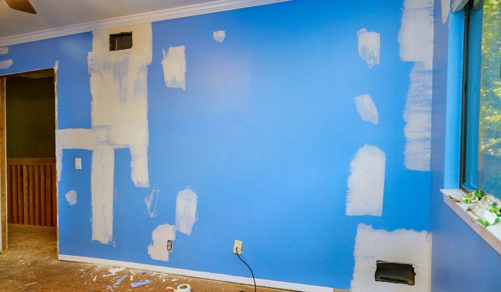 repair damaged cracks on walls drywall ceilings use spatula for putting gypsum