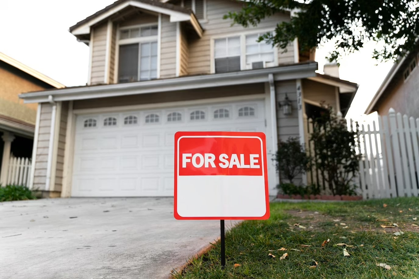 house with yard sign for sale