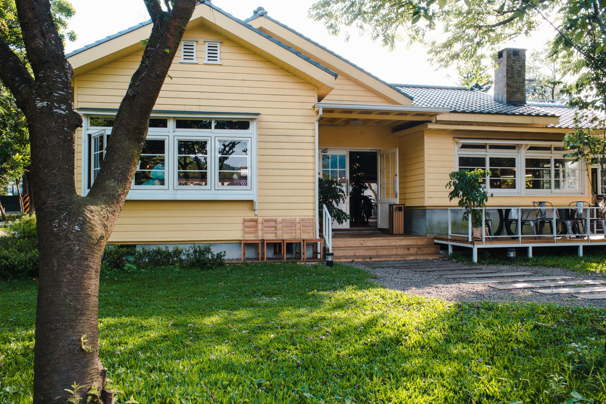 charming yellow house with wooden windows