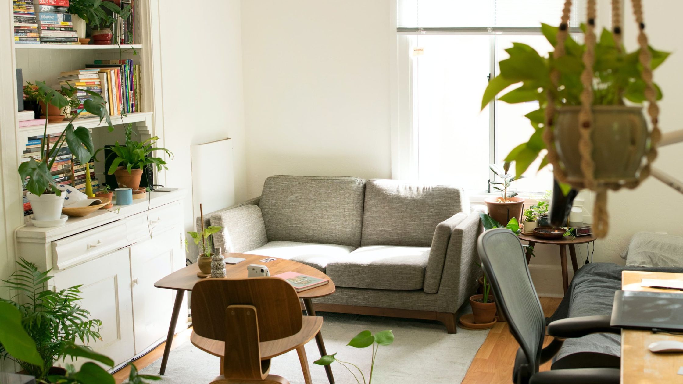 gray fabric loveseat near wooden table