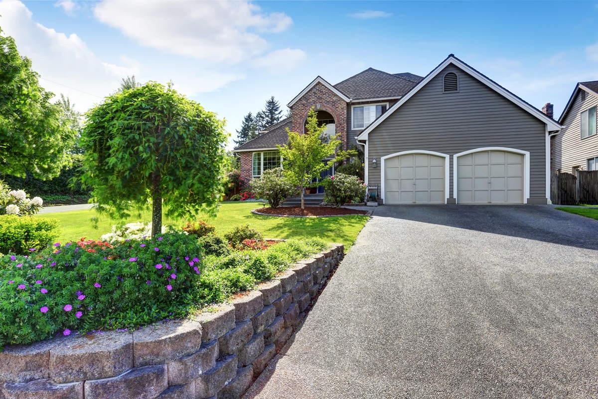 luxury house exterior with brick and siding trim and double garage