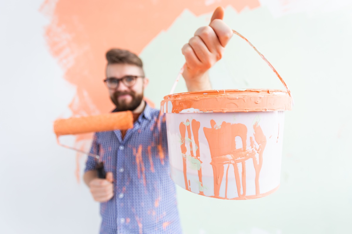 painter holding paint can