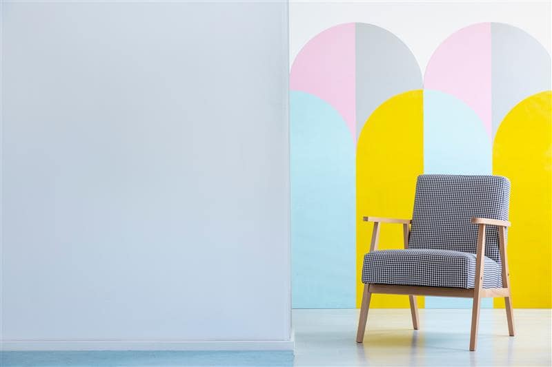 armchair with checkered pattern feature wall