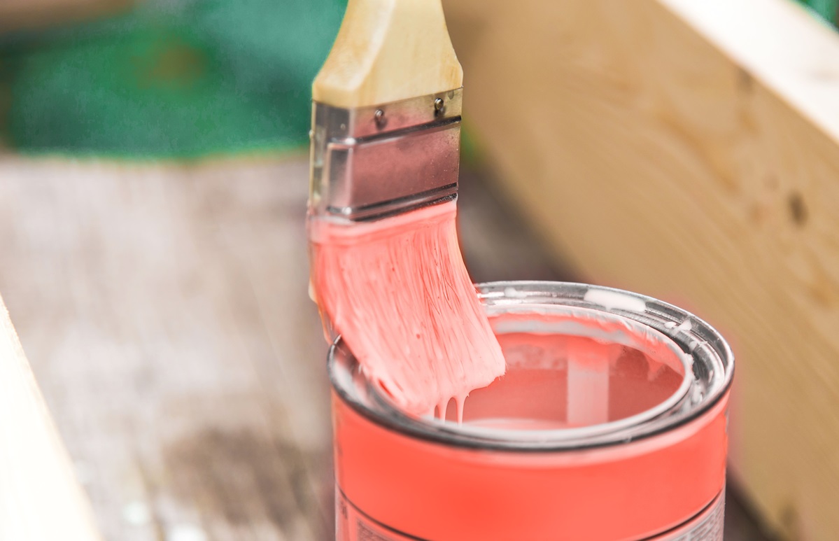 brush dipped in a jar with paint