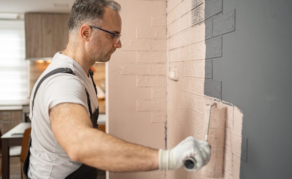 man working on brick wall