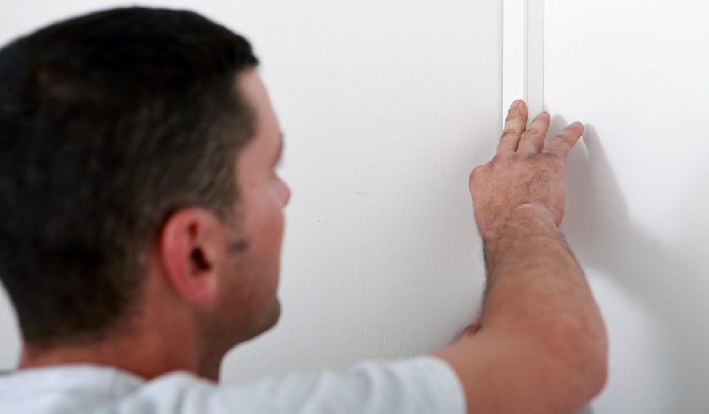 man concealing wiring