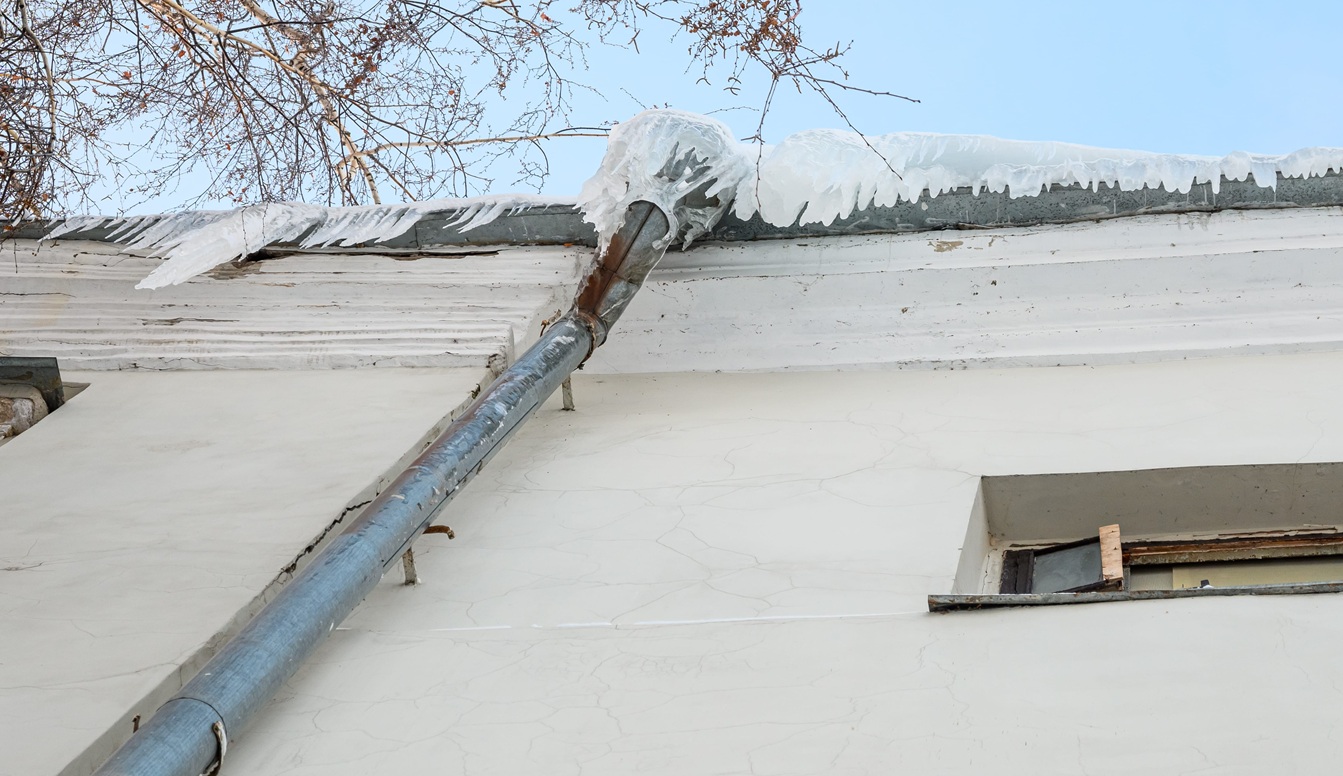 Roof of a building with snow and hanging icicles